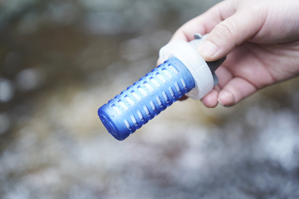 Close-up of a JEYOGO replacement filter cartridge held outdoors