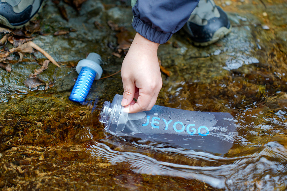 Filling the JEYOGO bottle from a freshwater stream